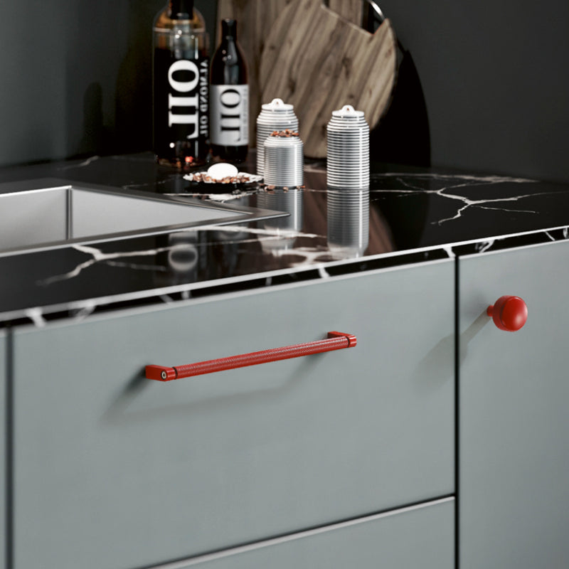 Matte Red Urban Modern Door Handle and Knob Mounted on Grey Kitchen Cabinet