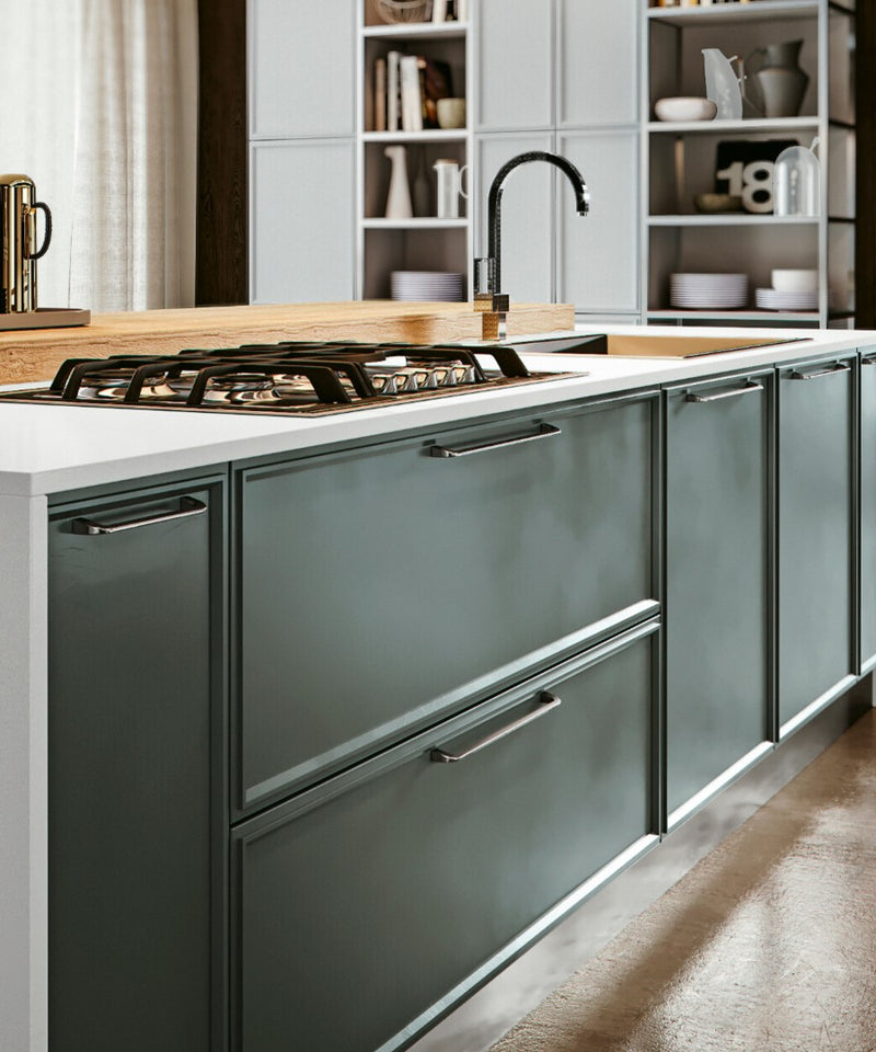 Westhill Handle Collection Mounted on Dark Green Kitchen Cabinet