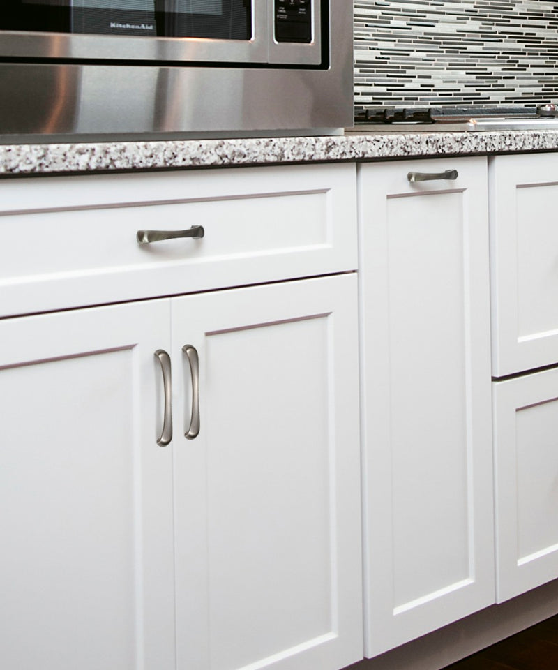 Functional Design Innerkip Cabinet Hardware in Brushed Nickel Mounted on the White Kitchen Cabinet