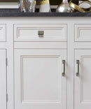 Classic Design Lambeth Kitchen Hardware - Antique Nickel Cabinet Handle and Knob Mounted on the White Cabinet