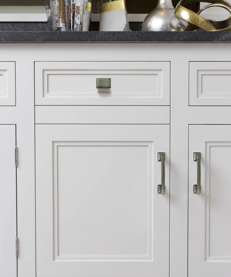 Classic Design Lambeth Kitchen Hardware - Antique Nickel Cabinet Handle and Knob Mounted on the White Cabinet