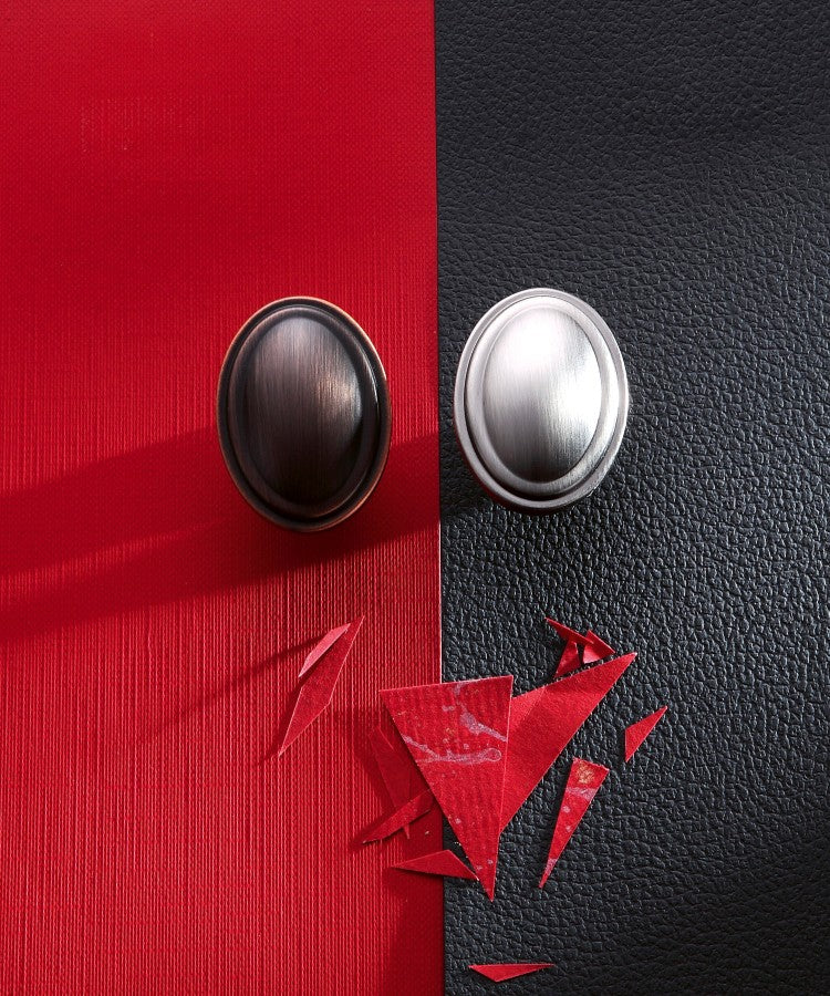 Display of Old Mill Knobs on Black and Red Kitchen Cabinet Background