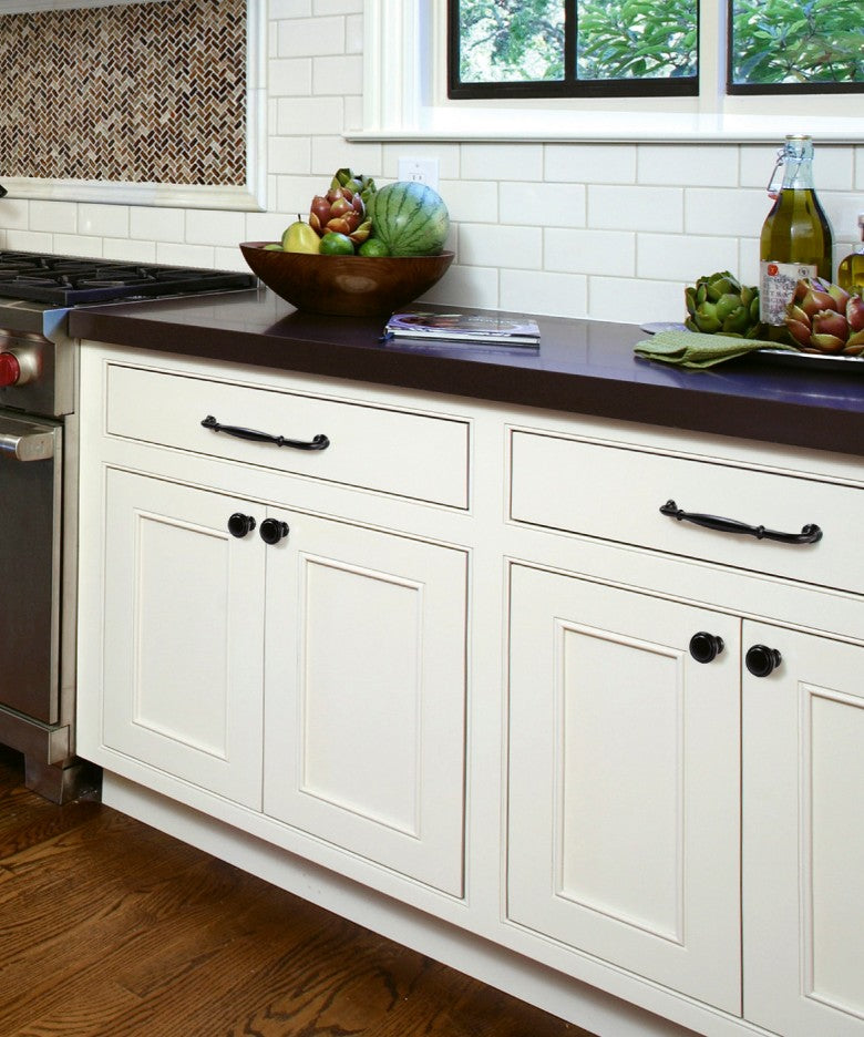 Vintage Matte Black Rosemont Handle and Knob Mounted on Cream White Kitchen Cabinet